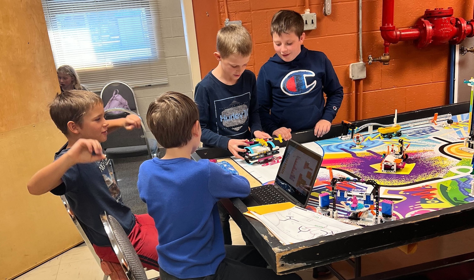 FLL Challenge kids working on their robot